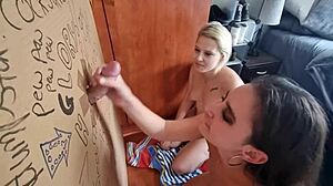 Amateur blonde and brunette babes give each other a double blowjob and glory hole fuck